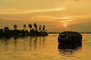 Calmness Prints: A traditional houseboat moves past the setting sun on the Kerala Backwaters, Kerala