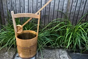 Japanese Gallery: Traditional Japanese wooden bucket and ladle for washing sidewalk in a custom called uchimizu