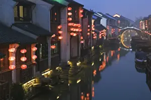 Illuminating Prints: Traditional old riverside houses illuminated at night in Shantang water town