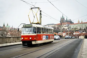 Railroad Track Prints: A traditional red tram crosses Manesuv most (bridge) with St