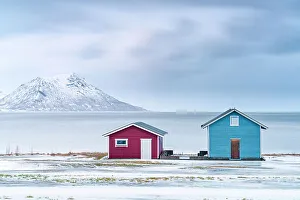 Rorbu Prints: Traditional rorbu cabins overlooking the frozen sea