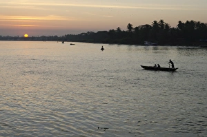 Sunsets Prints: Traditional rowing boat on the river at sunset