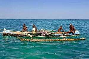 Traditional rowing boat in the turquoise water of the Indian Ocean, Madagascar, Africa