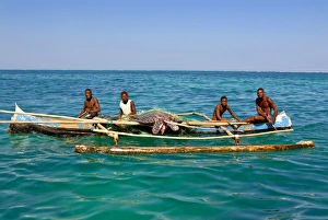 Traditional rowing boat in the turquoise water of the Indian Ocean, Madagascar, Africa Traditional rowing boat in the turquoise water of the Indian Ocean, Madagascar, Africa