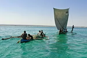Traditional sailing boat and rowing boat in the turquoise water of the Indian Ocean