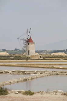 Traditional sea salt beds and windmill, Mozia, Sicily, Italy, Europe