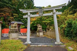 Shinto Prints: Traditional Shinto torii gate with guardian lion-dog statues surrounded by autumn foliage on Mount Hiei