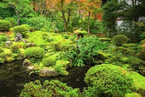 Lantern Prints: Traditional stone lantern by a tranquil pond surrounded by moss and autumn foliage in Shuheki-en Garden