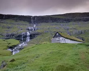 Images Dated 21st September 2009: Traditional turf roofed farm building and waterfall, Saksun, Streymoy Island