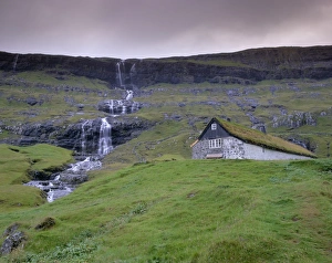 Images Dated 21st September 2009: Traditional turf roofed farm building and waterfall, Saksun, Streymoy Island