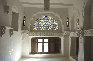 Traditional upper window of stained glass in upstairs room within the Dhar Alhajr