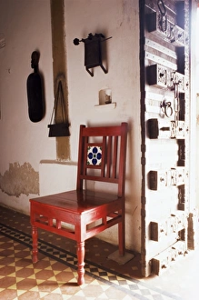 Traditional wood door and 19th century floor tiles