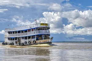 Manaus Prints: Traditional wooden boat navigating on the Rio Negro