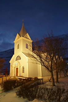 Traditional wooden church at night, built in 1922, at Seydisfjordur, a town founded in 1895 by a Norwegian fishing company, now main ferry port to and from Europe in the East Fjords, Iceland