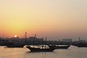 Qatar Prints: Traditional wooden dhow boats in the Corniche marina