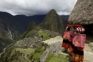 Machu Picchu Prints: Traditionally dressed children looking over the ruins of the Inca city of Machu Picchu