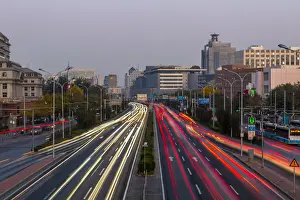 Traffic trail lights on major road near Beijing Zoo at dusk, Beijing, People s
