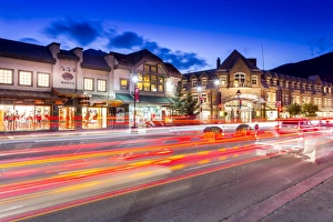 Trail lights and shops on Banff Avenue at dusk, Banff, Banff National Park, Alberta