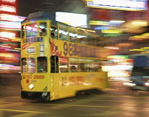 Trams Prints: Tram in blurred motion at dusk, Causeway Bay, Hong Kong, China, Asia