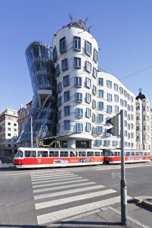 Tram in front of the Dancing House (Ginger and Fred) by Frank Gehry, Prague, Bohemia, Czech Republic, Europe