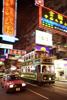 Images Dated 2nd April 2007: Tram and taxi with neon lights, Hong Kong, China, Asia