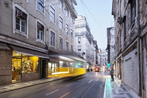 Unrecognisable Person Prints: Trams in the streets of Lisbon, Portugal, Europe