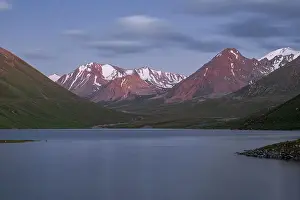 Rugged Terrain Prints: Tranquil evening at a high-altitude Kol-Ukok lake surrounded by majestic mountains in Kyrgyzstan