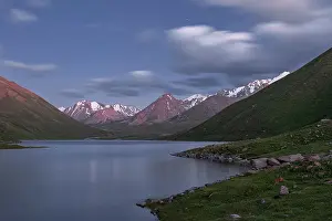 Foothills Prints: Tranquil evening at a high-altitude Kol-Ukok lake surrounded by majestic mountains in Kyrgyzstan