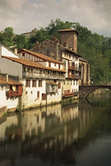 Tranquil scene of houses reflected in water, village of St. Jean Pied de Port in the Pyrenees