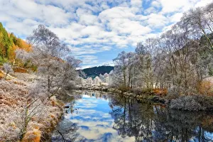 A tranquil view of Loch Doilet and surrounding trees on a calm and frosty winter