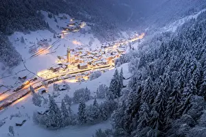 Valtellina Prints: Trees covered with snow in the winter forest surrounding the alpine village at Christmas
