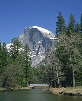 Half Dome Prints: Trees beside a river frame the snow capped Half Dome