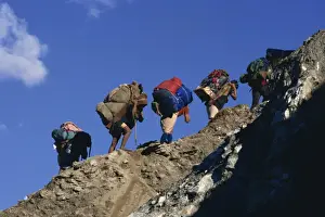Trek porters on eroded trail to Ghorapani Pass near Chitre, Nepal, Asia