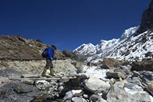 Senior Man Prints: Trekker crossing the Chola Khola valley near Dzonglha