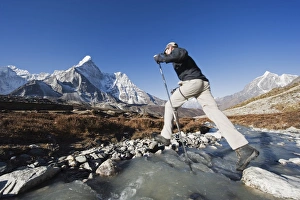 Trek Prints: Trekker crossing a mountain stream, Ama Dablam, 6812m, behind, Solu Khumbu Everest Region