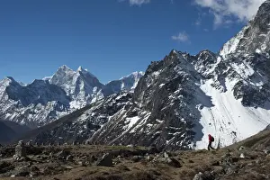 45 49 Years Prints: A trekker in the Everest region on the way up to Everest Base Camp seen here walking