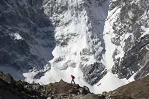 Challenge Prints: A trekker in the Everest region on the way up to Everest Base Camp walking in front of Cholatse