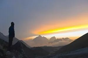 Images Dated 10th April 2010: Trekker watching the sunset over Cholatse, 6335m, Solu Khumbu Everest Region