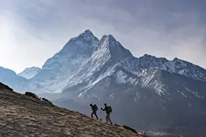 Stereotypically Nepalese Prints: Trekkers climb a small peak above Dingboche in the Everest region in time to see the sunrise