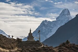 Images Dated 8th April 2009: Trekkers near a chorten in the Everest region with the peak of Ama Dablam in the distance