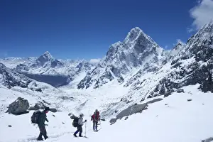 Solukhumbu District Prints: Trekkers walking over Cho La Pass with Ama Dablam on left and Arakam Tse on right