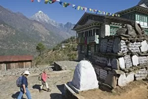 Images Dated 20th March 2010: Trekkers walking past a mani stone, Solu Khumbu Everest Region, Sagarmatha National Park