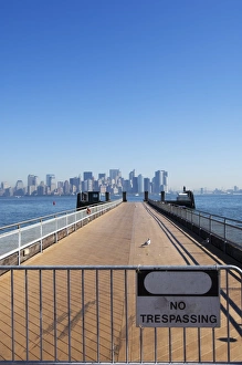 Liberty Island Prints: No trespassing sign on jetty facing Manhattan skyline