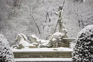 Triton statue in snow, Paseo del Prado, Madrid, Spain, Europe