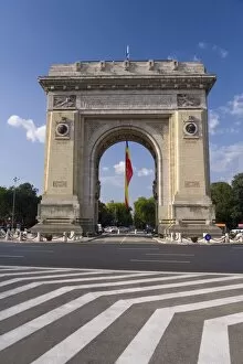 Triumphal Arch (Arcul de Triumf) and Romanian flag, Bucharest, Romania, Europe