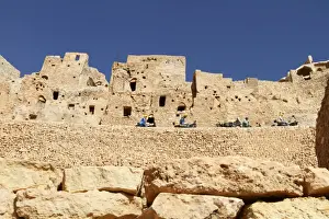 Cave Dwellings Prints: Troglodyte cave dwellings and local workers using donkeys