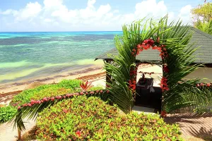 Love Prints: Tropical wedding decorations set near the ocean at a resort on Praslin Island in Seychelles