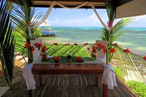 Love Prints: Tropical wedding setup at Coco de Mer resort in Seychelles with ocean views and floral decorations for a special event