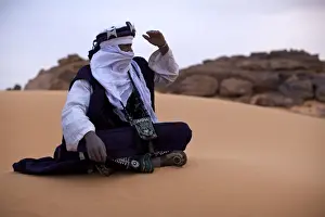 Tuareg Prints: A Tuareg dressed for celebrations at the entrance of the Dar Sahara tented camp in the Fezzan desert