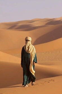 Bare Foot Prints: A Tuareg on the dunes of the erg of Murzuk in the Fezzan desert, Libya